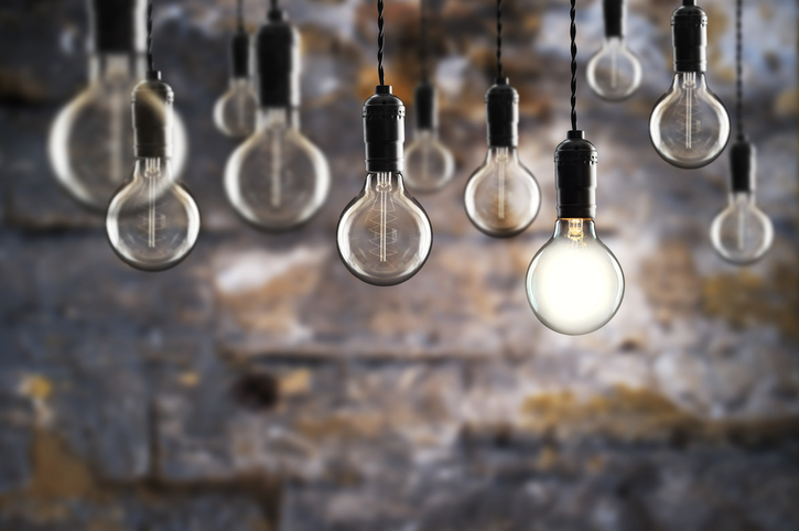 Idea and teamwork concept Vintage bulbs on wall background